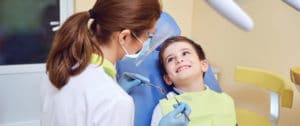 Pediatric Dentist looking at patient